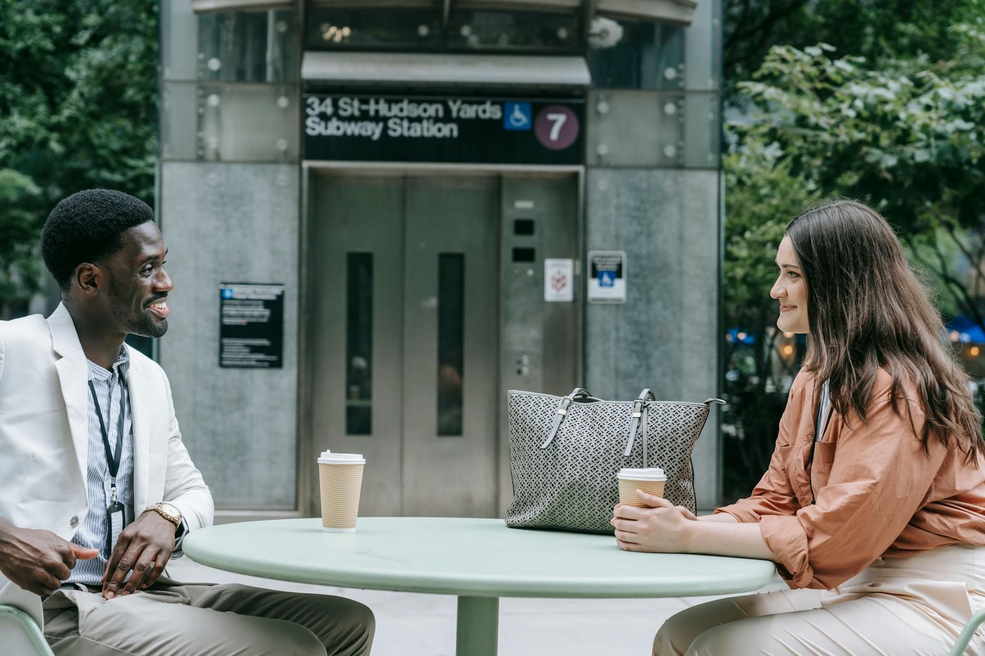 Woman and a man sitting near metro station elevator