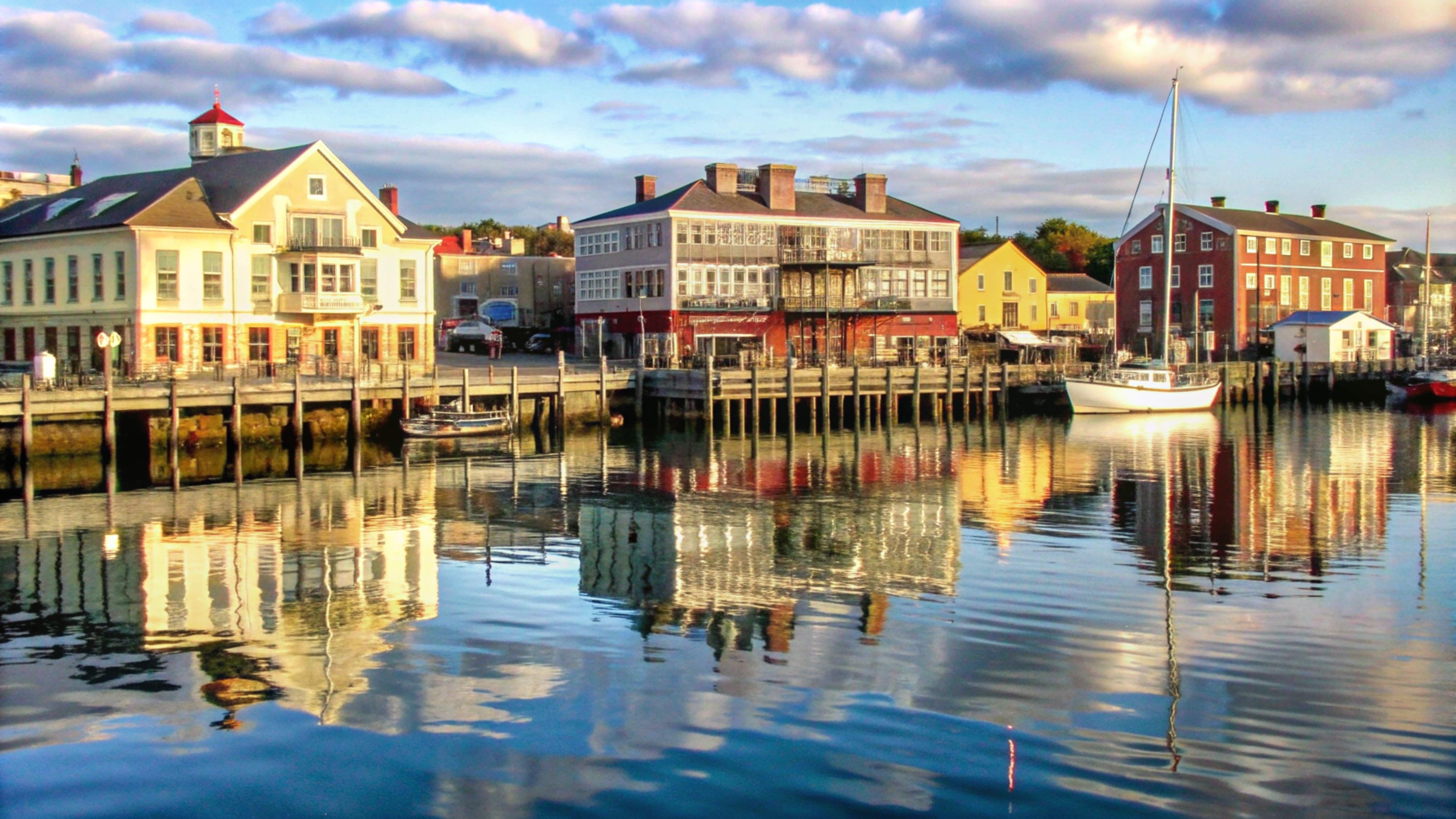 colorful-waterfront-buildings-reflected-calm-water.jpg