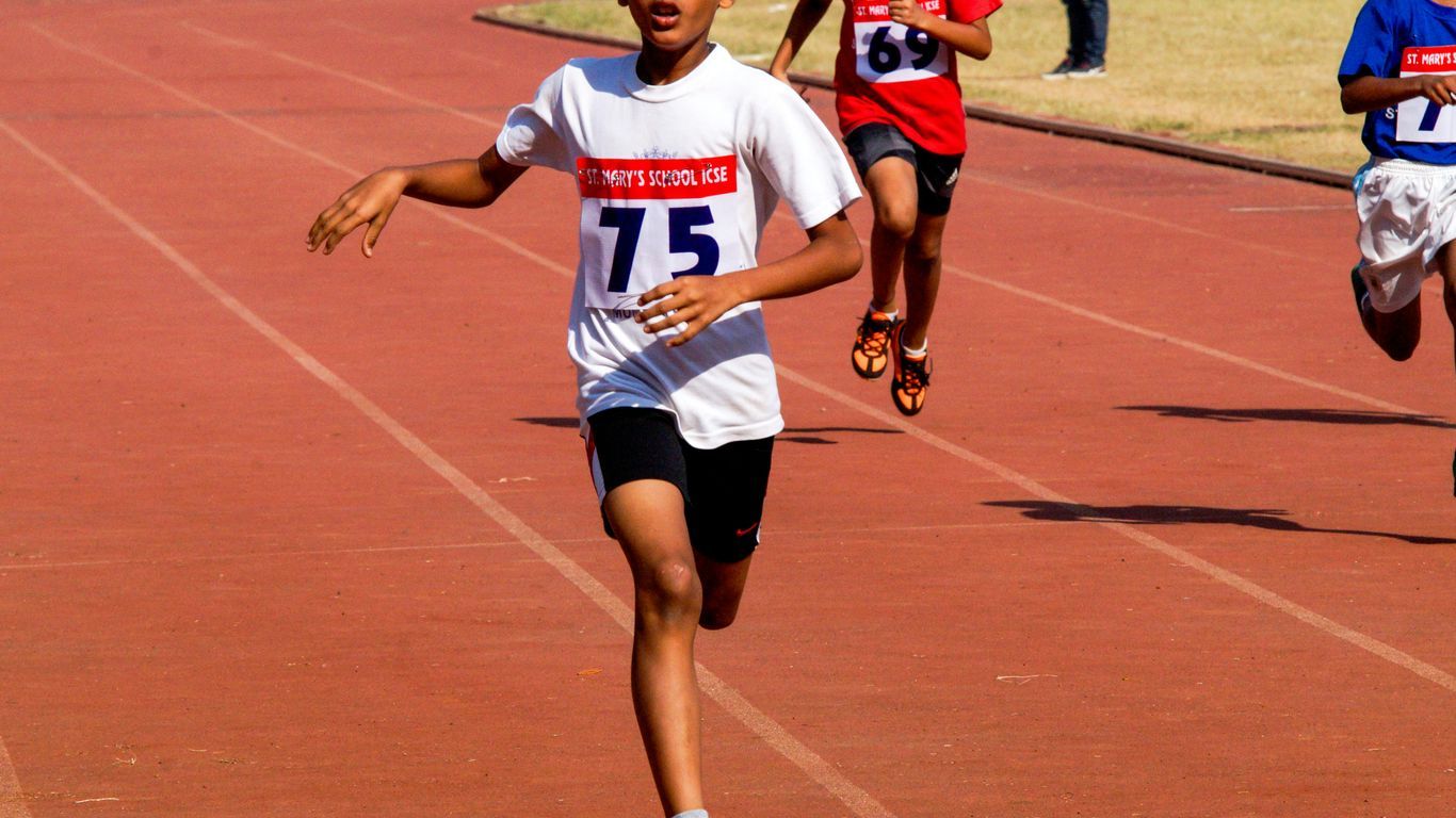 A group of children running on a track