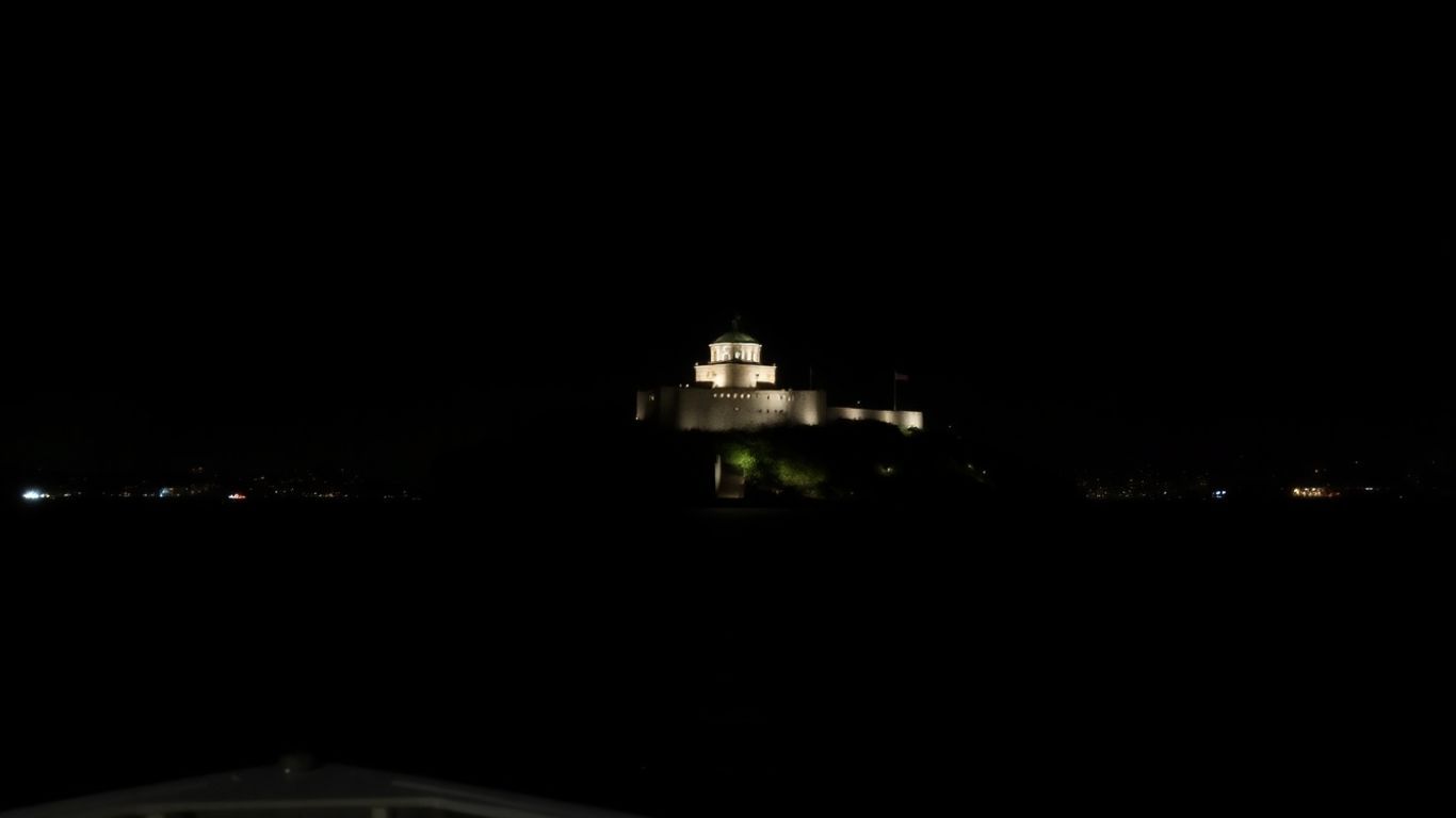 Alcatraz Island prison illuminated at night from the bay.