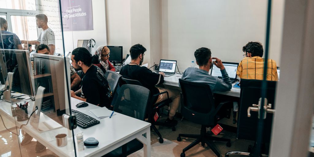 a group of people sitting at computers