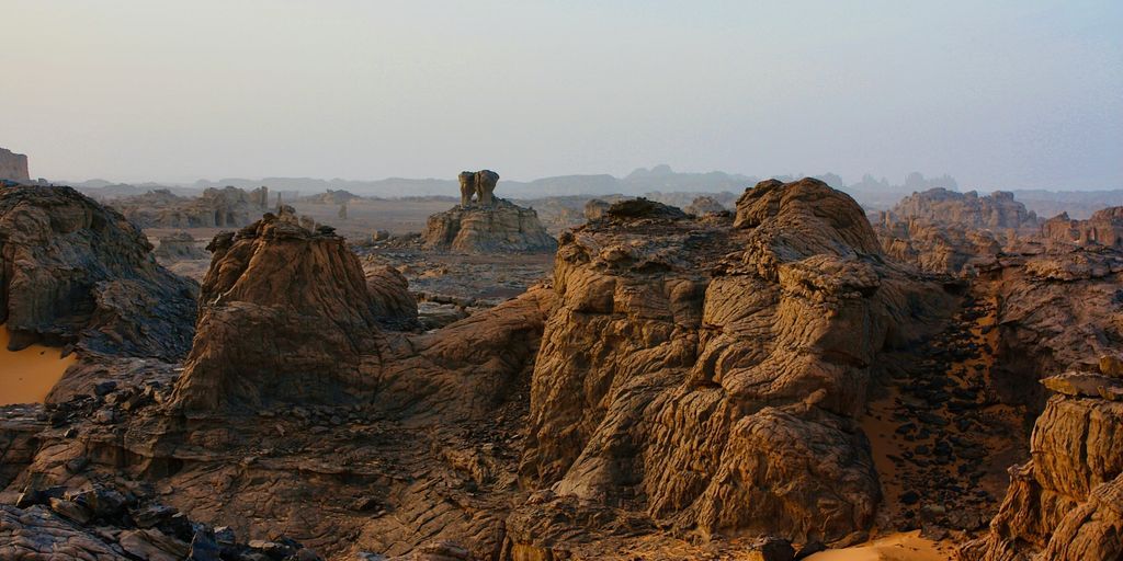 a rocky landscape with a elephant standing on top of it