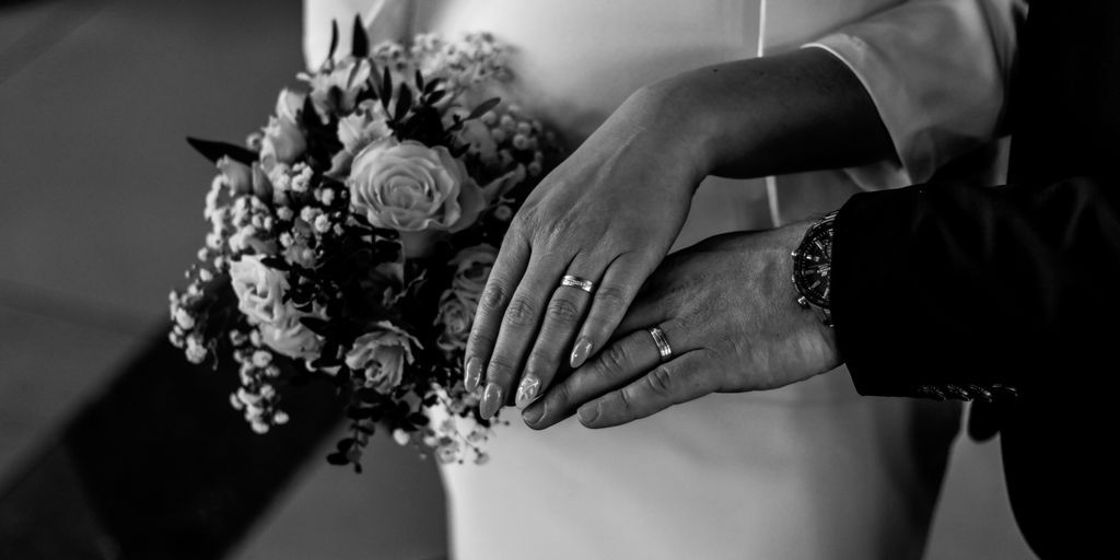 a close up of a person holding a bouquet of flowers