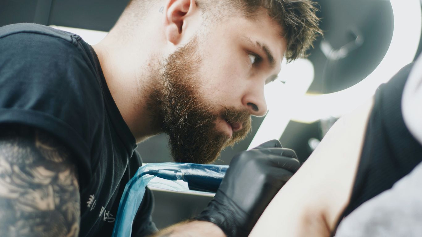 a man with a goatee and a beard sitting in a chair