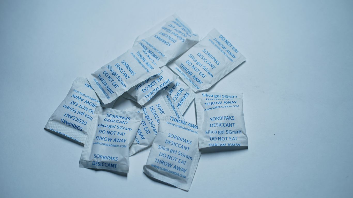 Small white packets with blue text on a light background