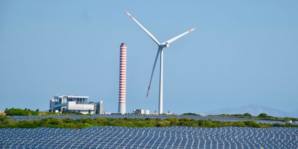 A wind farm with a wind turbine in the background
