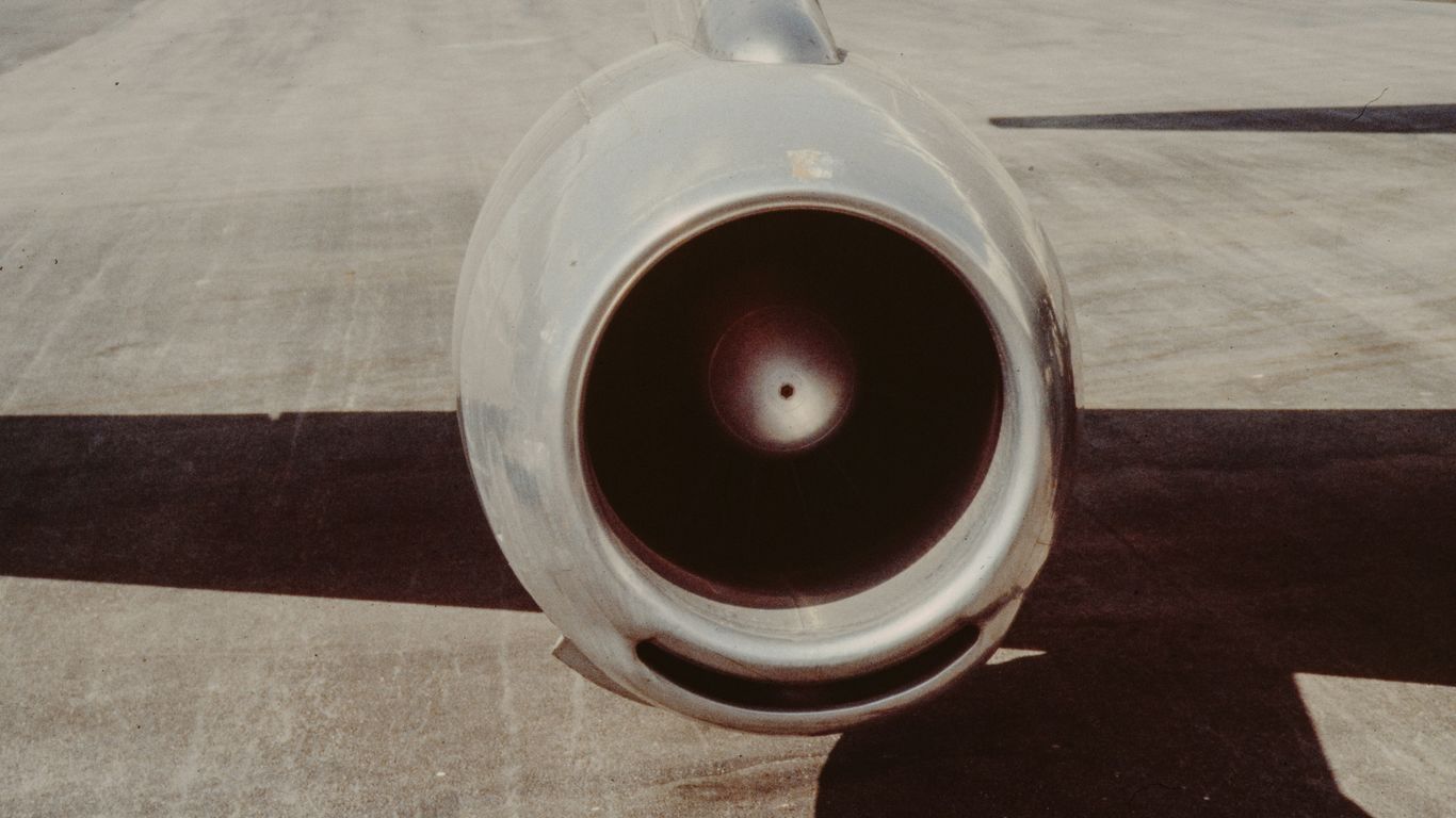 Close-up of a jet engine on tarmac.
