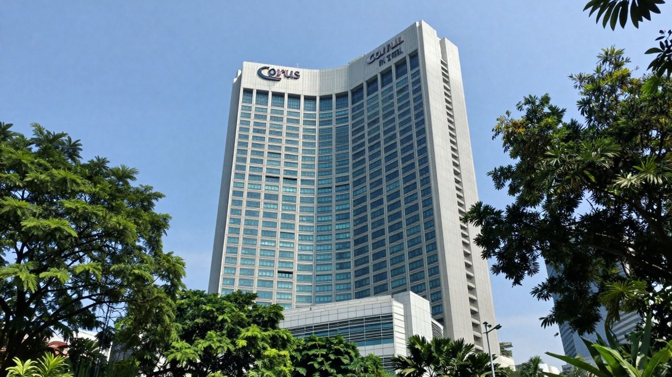 Corus Hotel Kuala Lumpur exterior with trees and blue sky.
