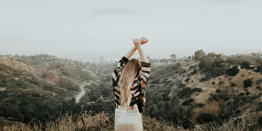 woman standing on top of mountain