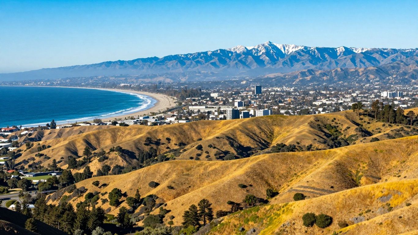 California landscape with mountains, coast, and city.