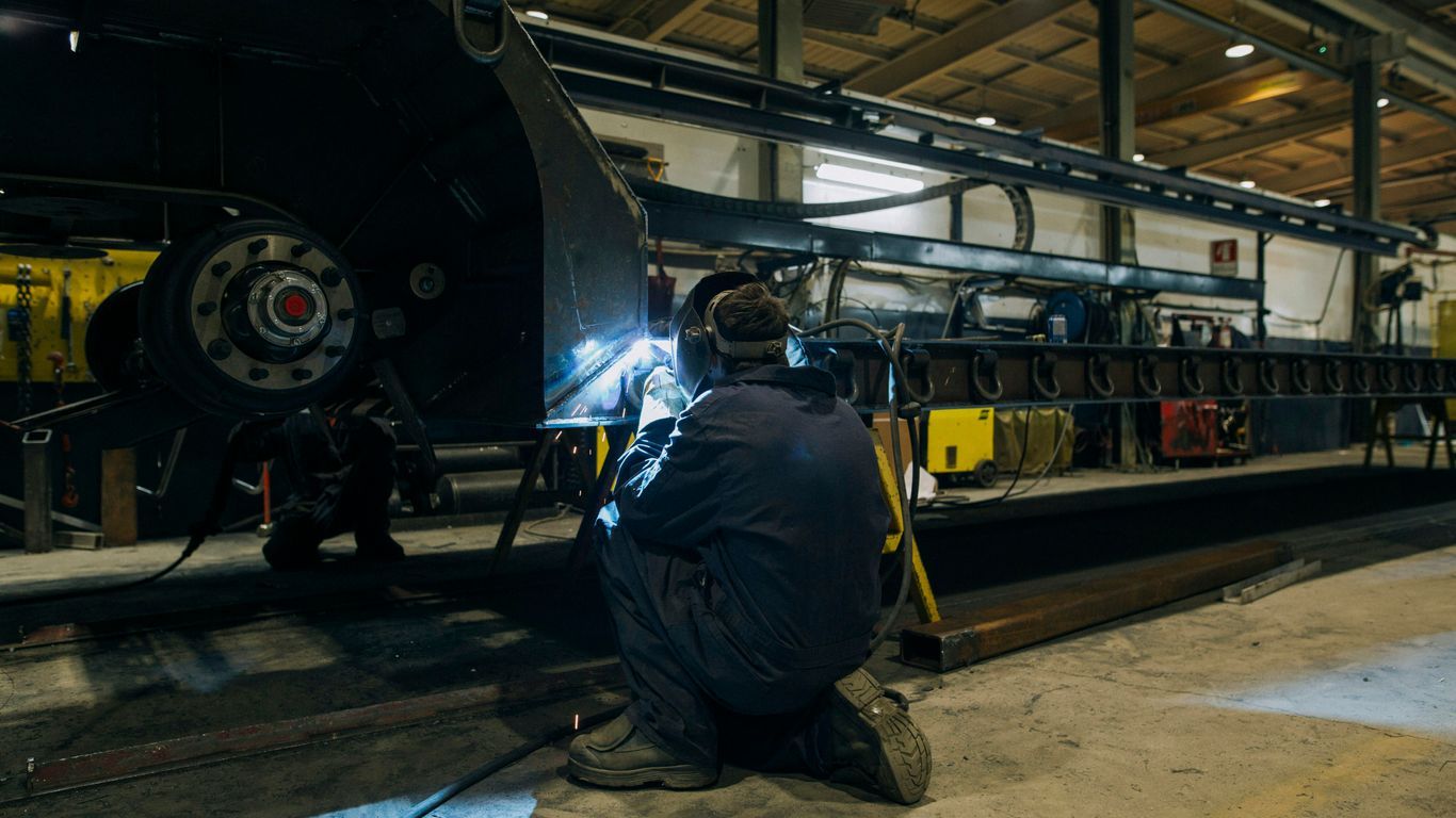 a man working on a machine in a factory