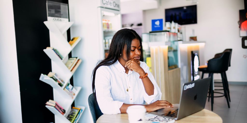 A woman sitting at a table with a laptop