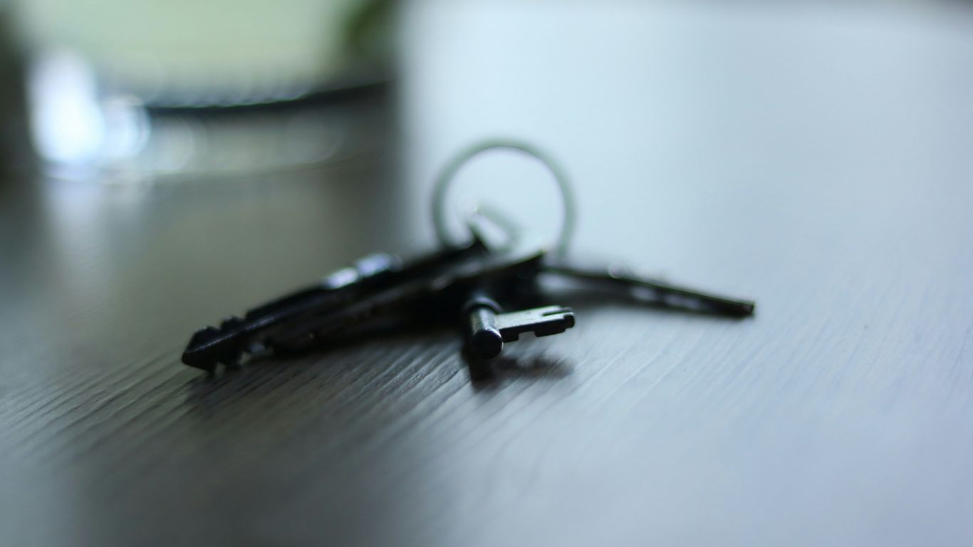 a pair of scissors sitting on top of a wooden table