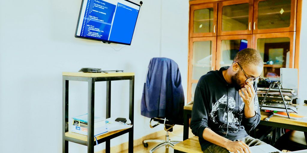 man using silver MacBook while sitting
