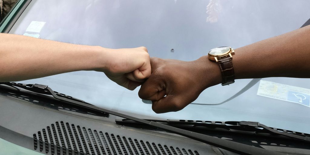 person wearing gold round analog watch