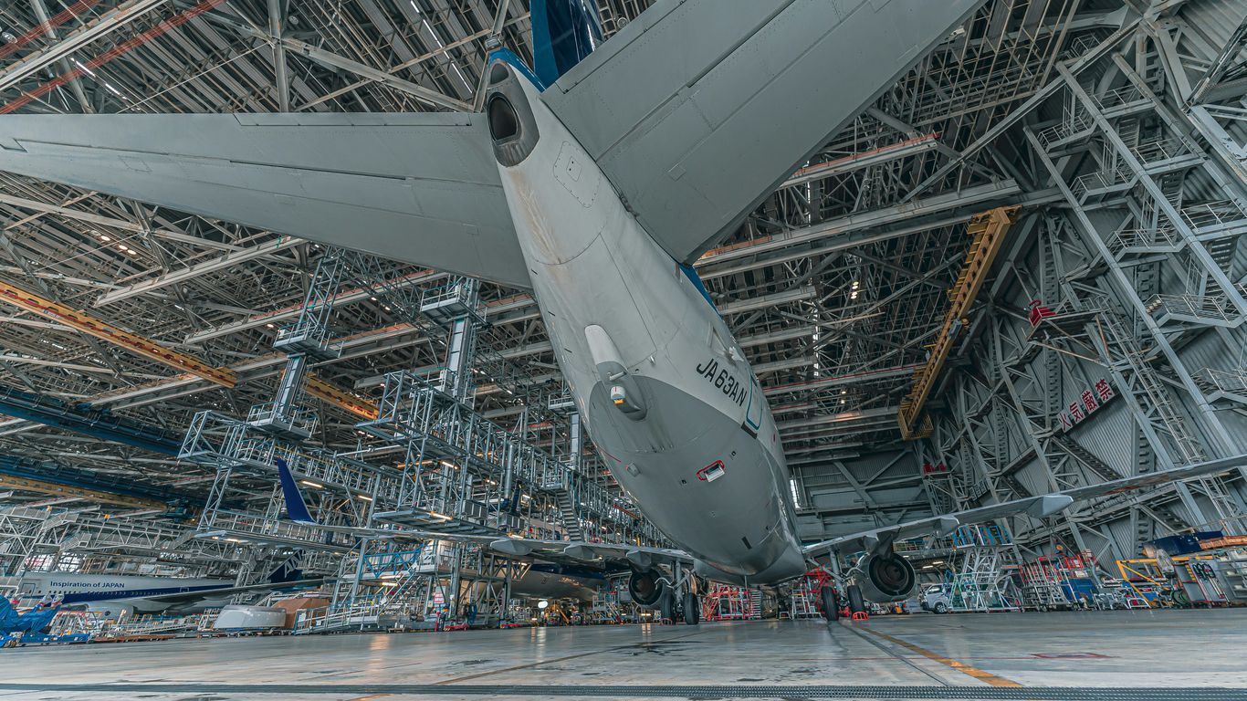 a large jetliner sitting inside of a hangar