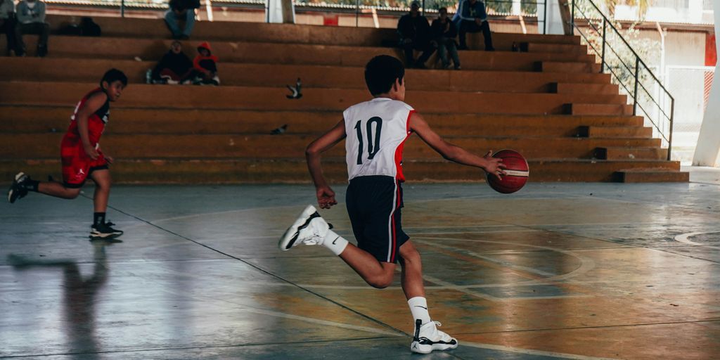 A group of young men playing a game of basketball
