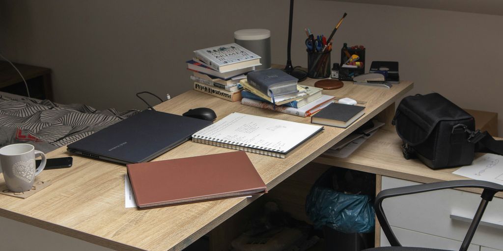 a wooden desk topped with a laptop computer
