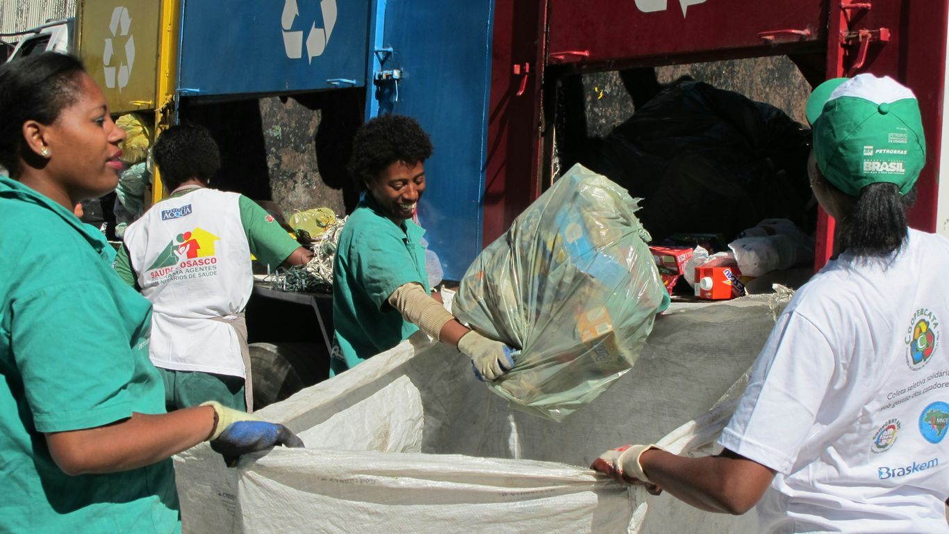 group of people sorting recycled bins