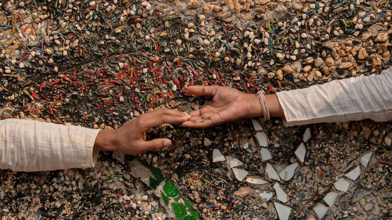 person in white pants and brown leather shoes standing on dried leaves