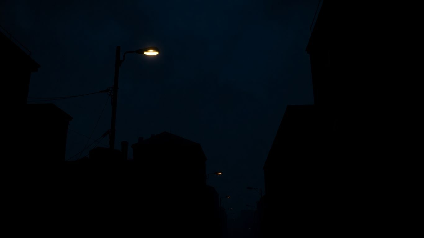 Dark city street at night with shadows.