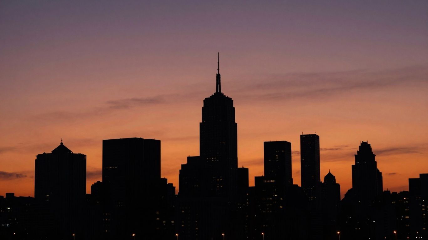 City skyline at dusk with streetlights glowing.