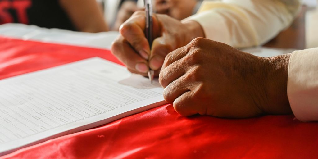 a person writing on a piece of paper