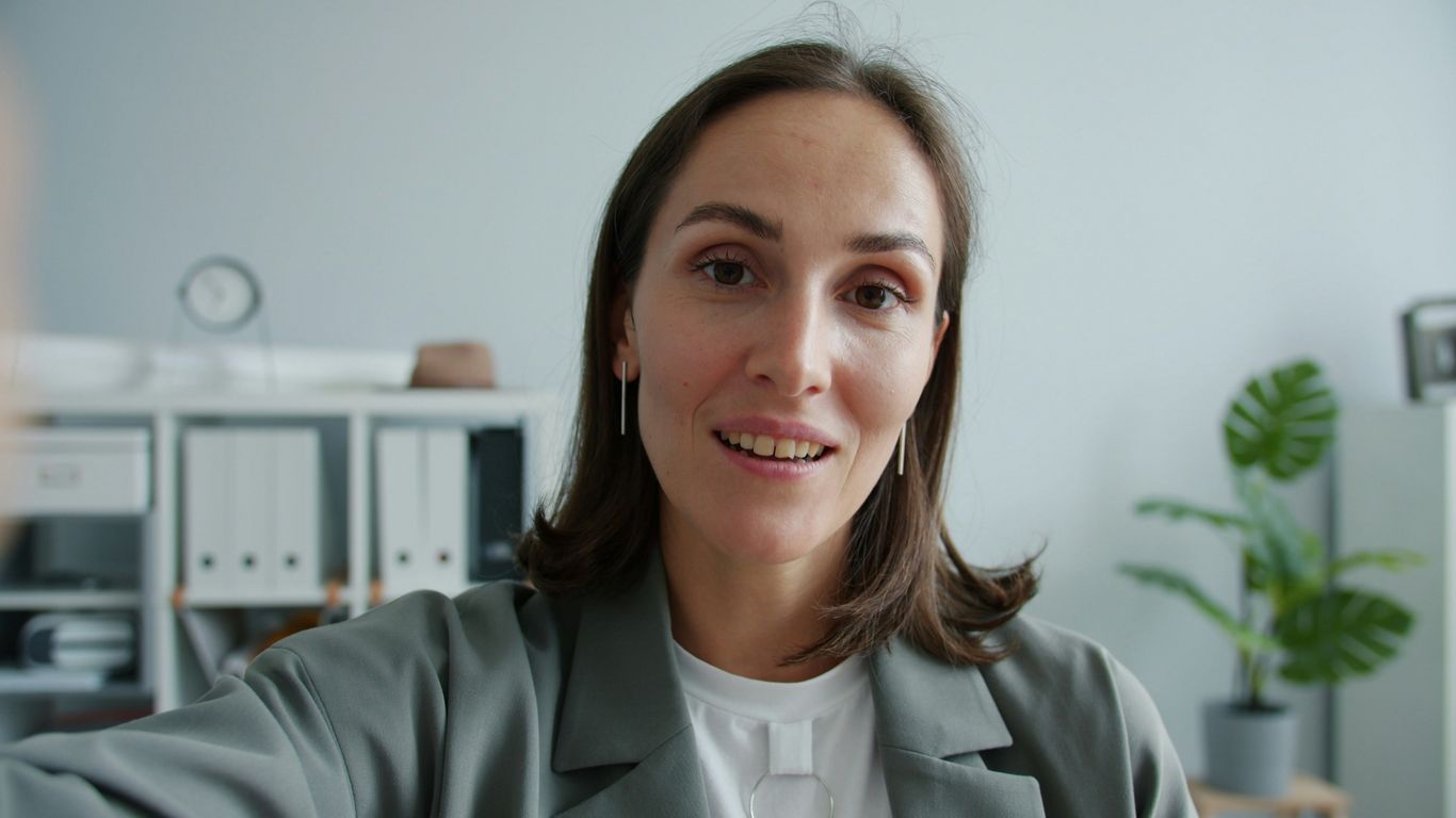 Woman in a suit looking at the camera.
