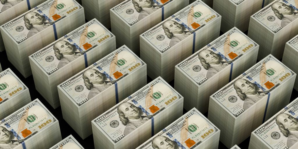 Stacks of hundred dollar bills are shown.