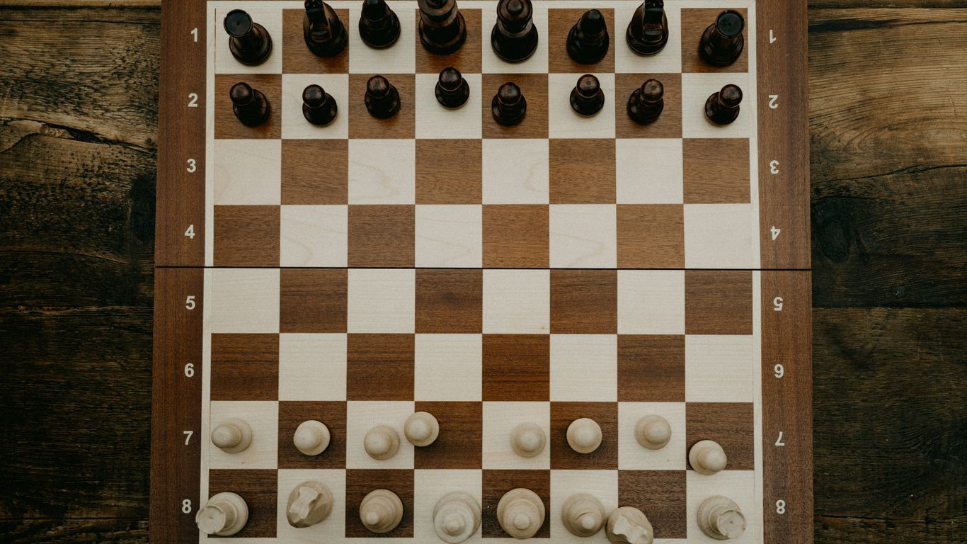 a wooden chess board with chess pieces on it