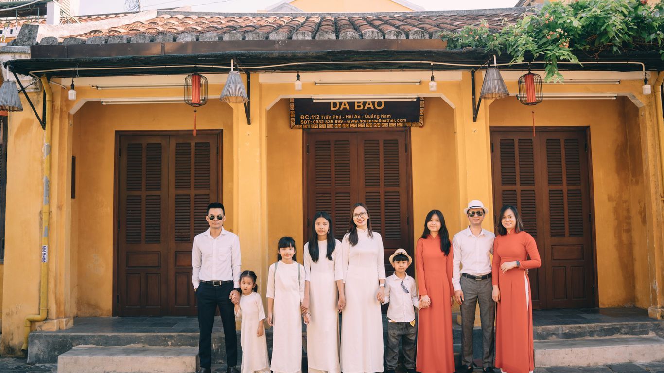 a group of people posing for a photo in front of a building