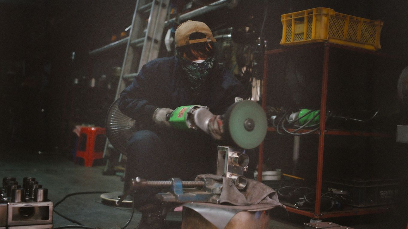 a man working on a machine in a factory