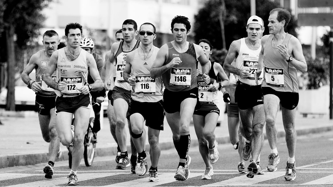 grayscale photo of people performing marathon