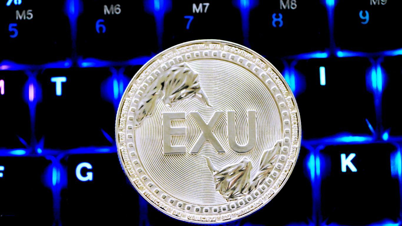 gold round coin on black computer keyboard