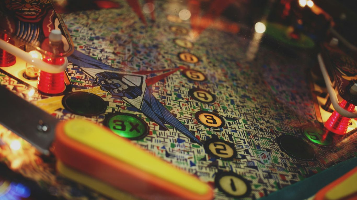 a close up of a pinball machine with a lit candle