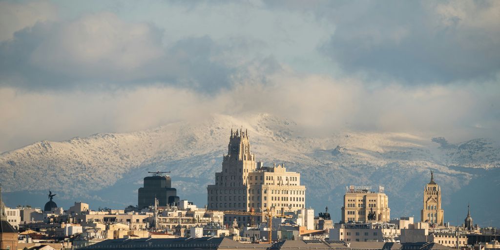 a view of a city with mountains in the background