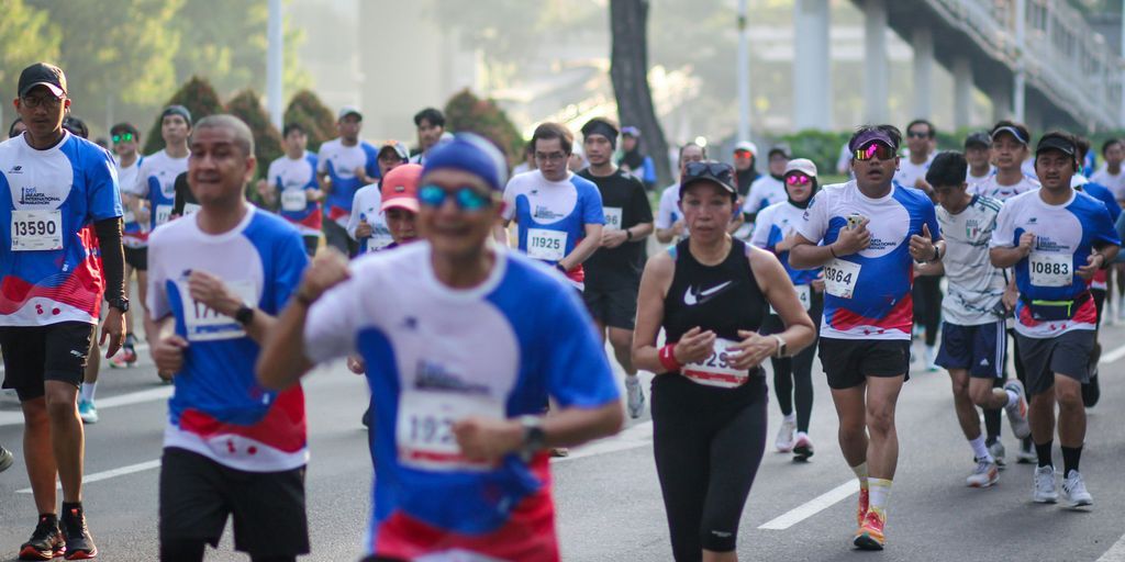A large group of people running down a street