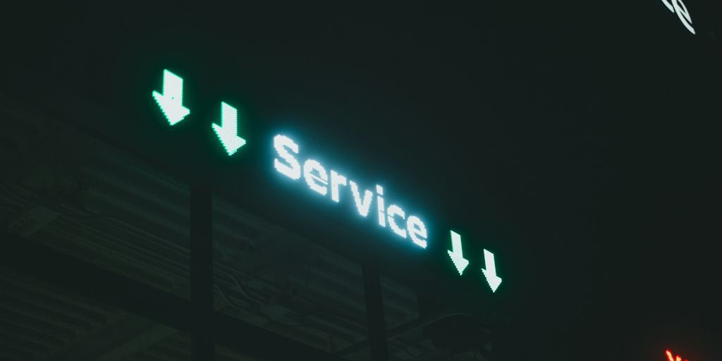 a lit up sign that says service i and x