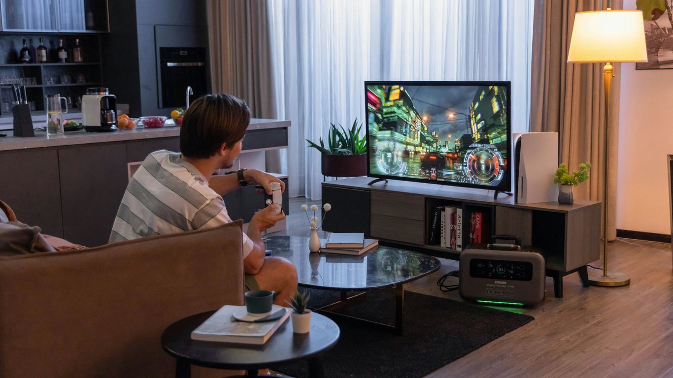 a man sitting in a chair in front of a tv