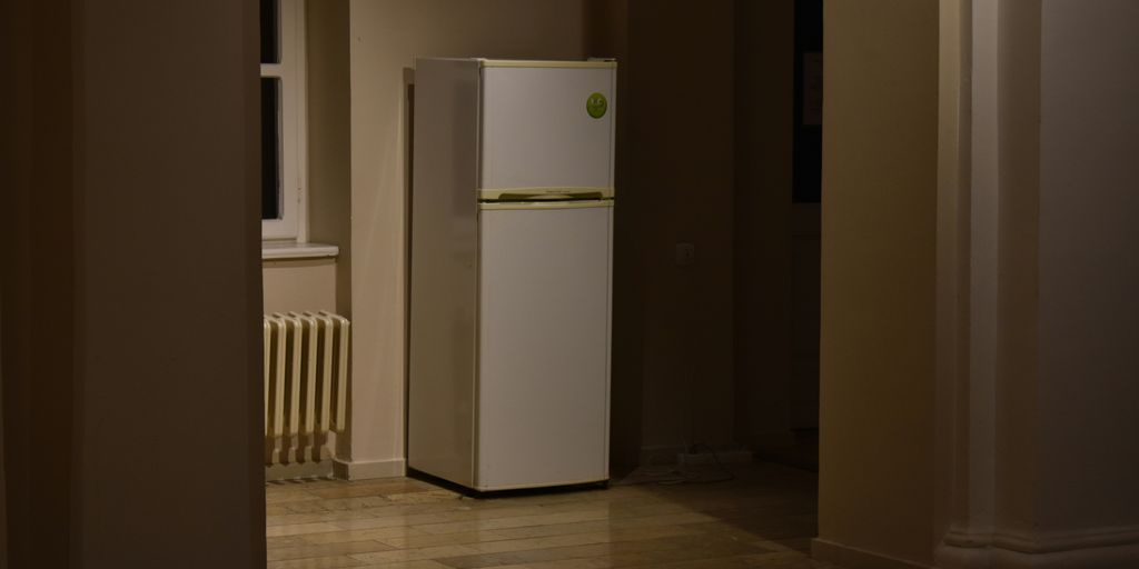 a white refrigerator freezer sitting inside of a kitchen