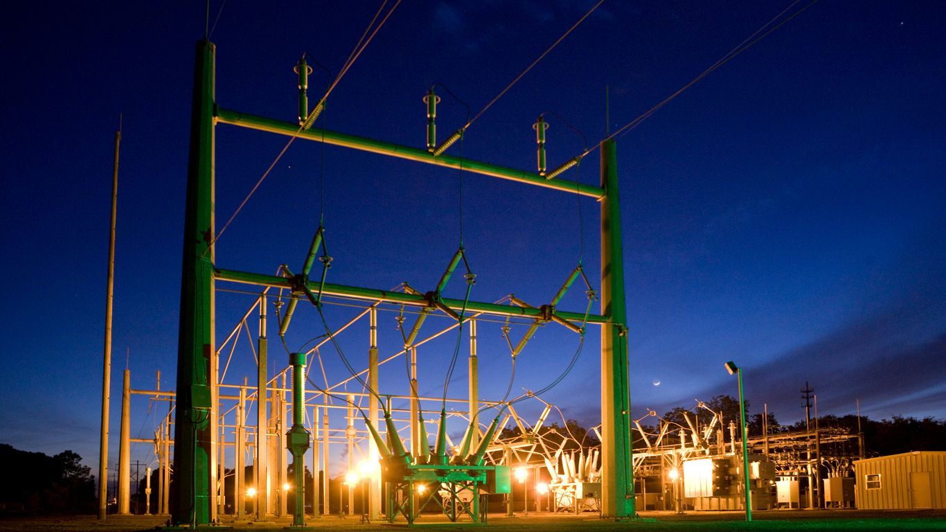 green and grey transmission tower during nighttime