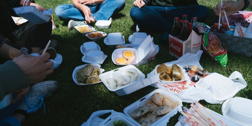 woman in blue tank top sitting on green grass field